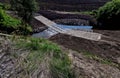 The dirt road leads across a stream that crosses river and continues Royalty Free Stock Photo