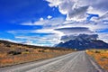 The dirt road leads to the mountain range Royalty Free Stock Photo