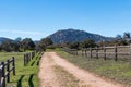 Dirt Road Lined with Wooden Fence Leading to Mount Woodson Royalty Free Stock Photo