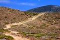 Dirt road on a mountain slope.Landscape in a sunny Royalty Free Stock Photo