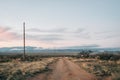 Dirt road and mountains at sunset in the desert of eastern Arizona Royalty Free Stock Photo