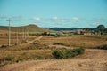 Dirt road passing through rural lowlands and ranch