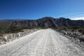 Dirt road perspective Tucuman Argentina valley calchaquies arid and dry with mountains rocks in Tafi del Valle conifers molles and Royalty Free Stock Photo