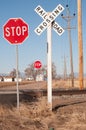 Dirt road with a railroad crossing controled with stop signs Royalty Free Stock Photo