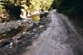 Dirt road after rain. Fragment of car off-road with autumn nature wet muddy of backcountry countryside Royalty Free Stock Photo