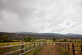 Dirt road on a ranch with a cloudy sky Royalty Free Stock Photo