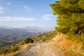 A dirt road on the rocky and arid but green coast, in Europe, Greece, Crete, towards Ierapetra, By the Mediterranean Sea, in Royalty Free Stock Photo