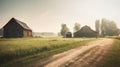 a dirt road running through a field next to two barns Royalty Free Stock Photo