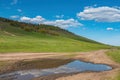 Dirt road rural countryside leading to the top of the hill, blue dramatic storm clouds Royalty Free Stock Photo