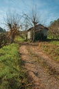 Dirt road on rural landscape with shabby shack