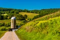 Dirt road and a silo in rural York County, Pennsylvania. Royalty Free Stock Photo