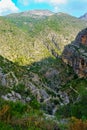 Dirt road with steps that curves down the mountain for hikers. Royalty Free Stock Photo