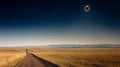 A dirt road stretches towards the horizon, with a total solar eclipse visible in the sky Royalty Free Stock Photo