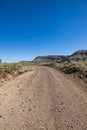 A dirt road stretching across a vast arid valley in northern Arizona
