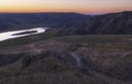 Dirt road to river at sunset. Steppe landscape of Kazakhstan near the city of Almaty with the Ili River Royalty Free Stock Photo