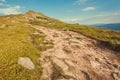 Dirt road to the top of green mountain. Nature landscape with rural way in grass. Beautiful scenery in the Carpathians Royalty Free Stock Photo