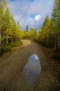 Dirt road to the top of Vottovaara mountain surrounded by autumn forest. Karelia, Russia Royalty Free Stock Photo