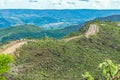 Dirt road on top of the hill surrounded by green natureDirt road on top of the hill surrounded by green nature. Royalty Free Stock Photo