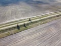 Dirt road between two plowed fields, aerial view. Agricultural land Royalty Free Stock Photo