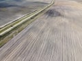 Dirt road between two plowed fields, aerial view. Agricultural land Royalty Free Stock Photo