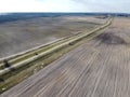 Dirt road between two plowed fields, aerial view. Agricultural land Royalty Free Stock Photo