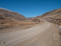 Dirt road uphill. Dangerous narrow dirt mountain road through the hills to a high-altitude village. Altai region Royalty Free Stock Photo