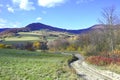 Rural road and autumn mountains landscape, Low Beskids Beskid Niski, Cigielka, Slovakia Royalty Free Stock Photo