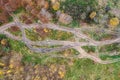 Dirt roads in wetland with puddles and mud after rain. aerial top view on off-road track