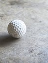 Dirt and scuff marks are visible on a used golf ball positioned on a dark surface, an image from generative ai Royalty Free Stock Photo