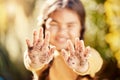 Dirt soil hands, girl child and gardening mockup with blurred background with smile, happiness and outdoor. Kid, garden