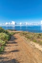 Dirt trail path overlooking blue sea and cloudy sky at Laguna Beach California Royalty Free Stock Photo