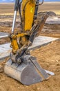 Dirt and an unfinished sidewalk by excavator arm Royalty Free Stock Photo