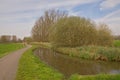 dirtroad and canal through a spring landscape in the flemish countryside