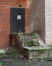 Dirty abandoned closed entrance to a brick building entrance