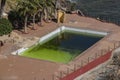 A dirty and abandoned pool with green water, scary pool, dyrty waterl, abandoned swimming pool, ruined pool
