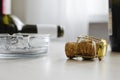 Dirty ashtray, cork and empty wine bottles on the table Royalty Free Stock Photo
