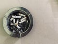 Dirty ashtray full of cigarette butts