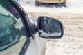 Dirty automobile mirror in the winter