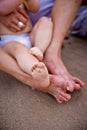 Dirty baby feet with beach sand, after playing with the waves and the sea in summer Royalty Free Stock Photo