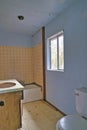 Dirty bathroom interior of an old and abandoned uninhabitable residential house Royalty Free Stock Photo