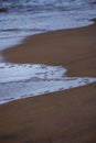 Dirty beach by the sea with storm clouds above in calm evening Royalty Free Stock Photo