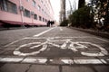 Dirty bike path in a city park on the background of blurry pedestrians