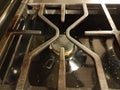 Dirty metal stove burner rack with crumbs and grease