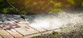 Dirty block pavement cleaning with high pressure washer. copy space Royalty Free Stock Photo