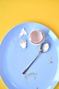 Dirty Blue Plate with Used Spoon and Egg Shell in Cup Royalty Free Stock Photo