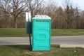 A Dirty, Blue Portable Toilet in a Park, nasty looking place to go to the bathroom Royalty Free Stock Photo