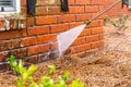 Dirty brick wall being cleaned with a pressure washer Royalty Free Stock Photo