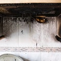 Dirty and burn domestic kitchen with black ashes