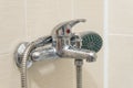 Dirty calcified shower mixer tap, faucet with limescale on it, close up