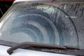 Dirty car back window covered mud.